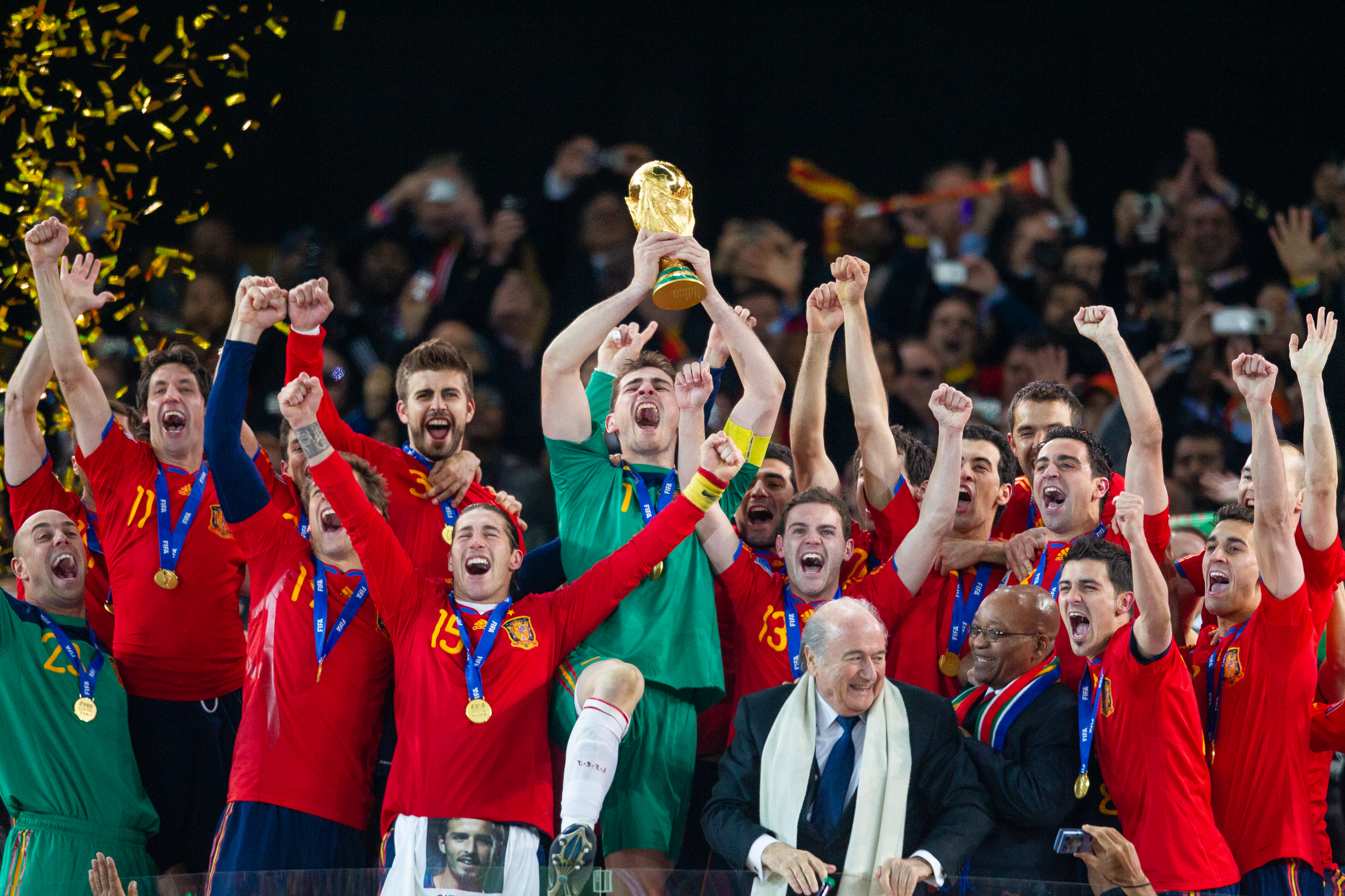Spain players celebrate their 2010 World Cup win as Iker Casillas lifts the trophy in South Africa.