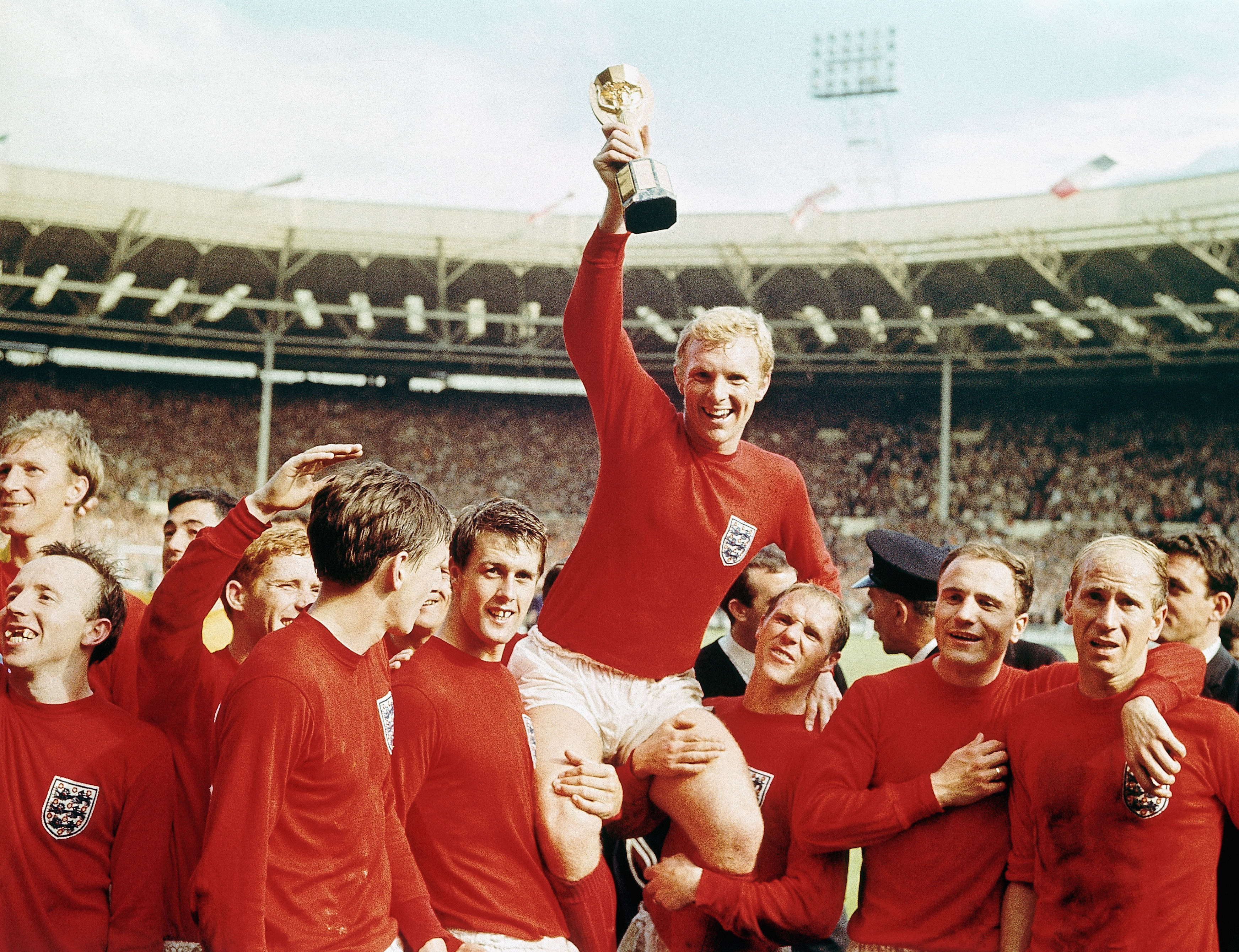 England captain Bobby Moore holds the Jules Rimet trophy aloft after victory over West Germany in the 1966 World Cup final